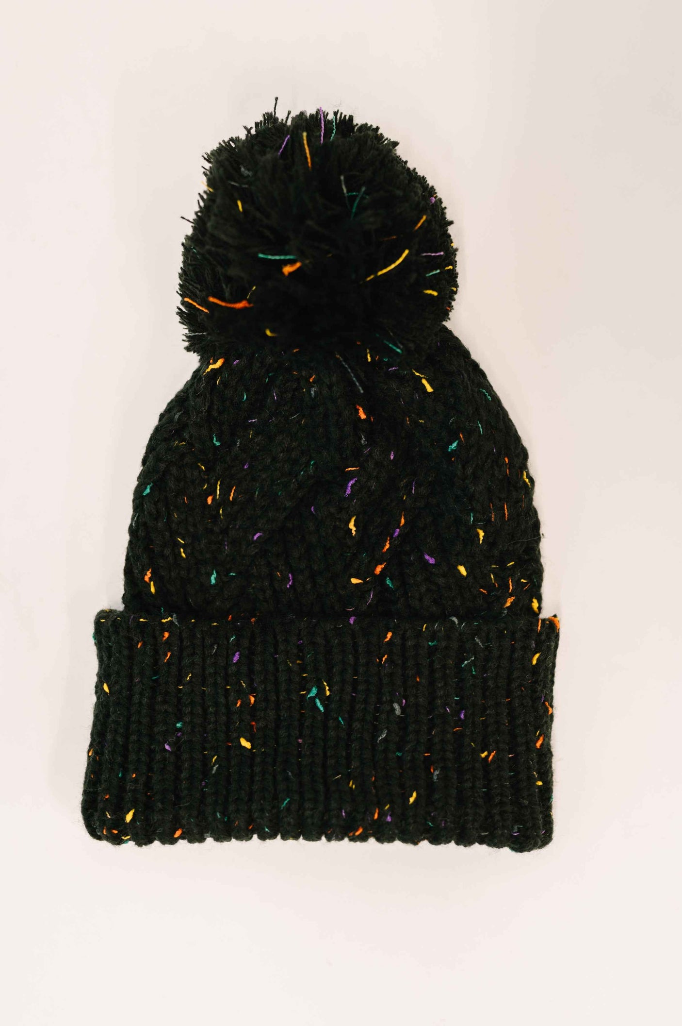Cover Your Ears Pom Pom Beanie in Black