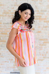 Blusa con mangas onduladas y flores de naranja